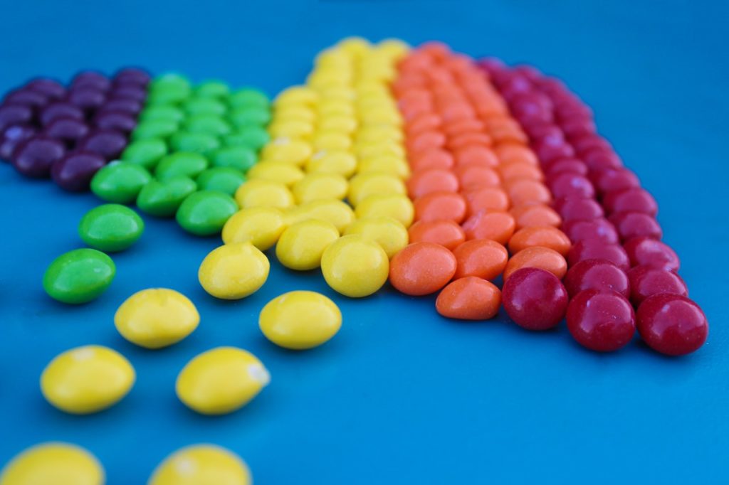 assorted colored skittles lined up