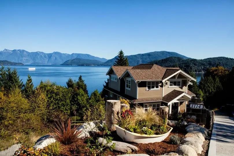 luxury house with a lake in the background